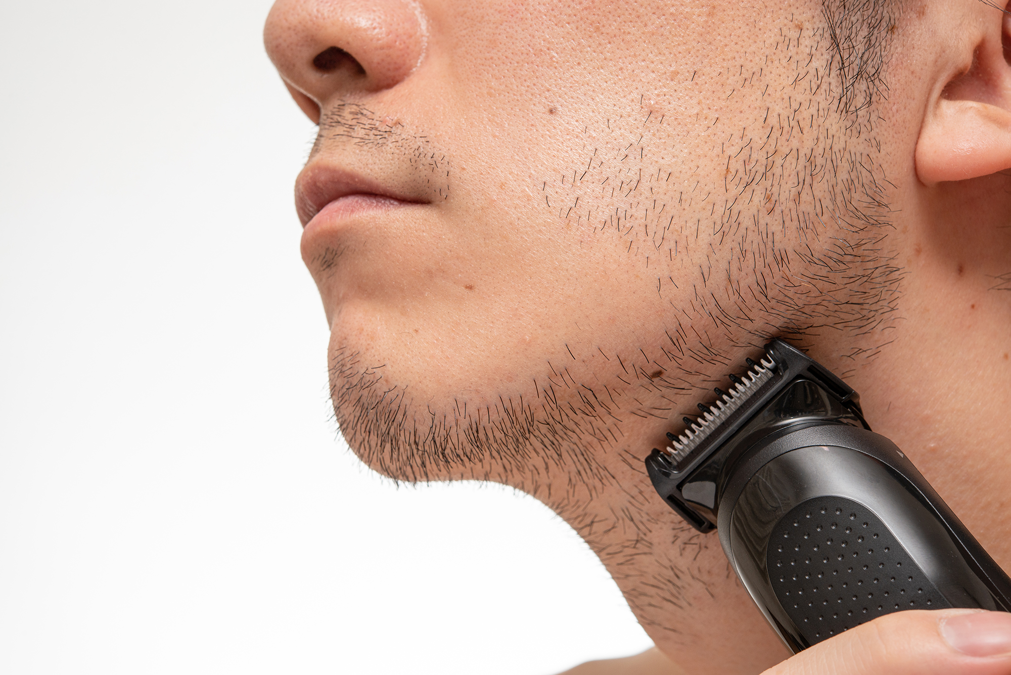 Trimming,The,Length,Of,His,Beard,With,Clippers.