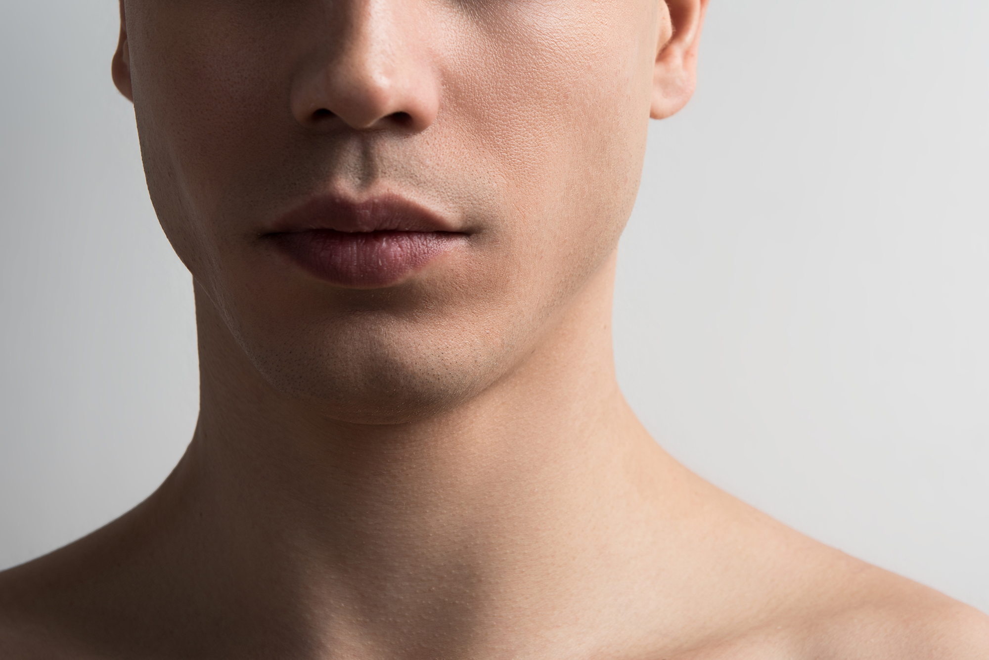 Pleasant topless youthful man is posing thoughtfully