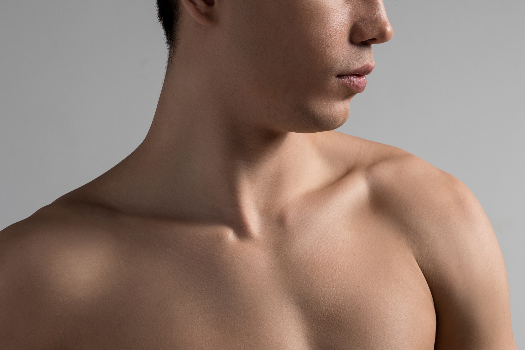 Serious youthful naked man is feeling pensiveness